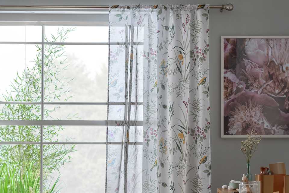 A pair of Habitat birds voile curtain panel.