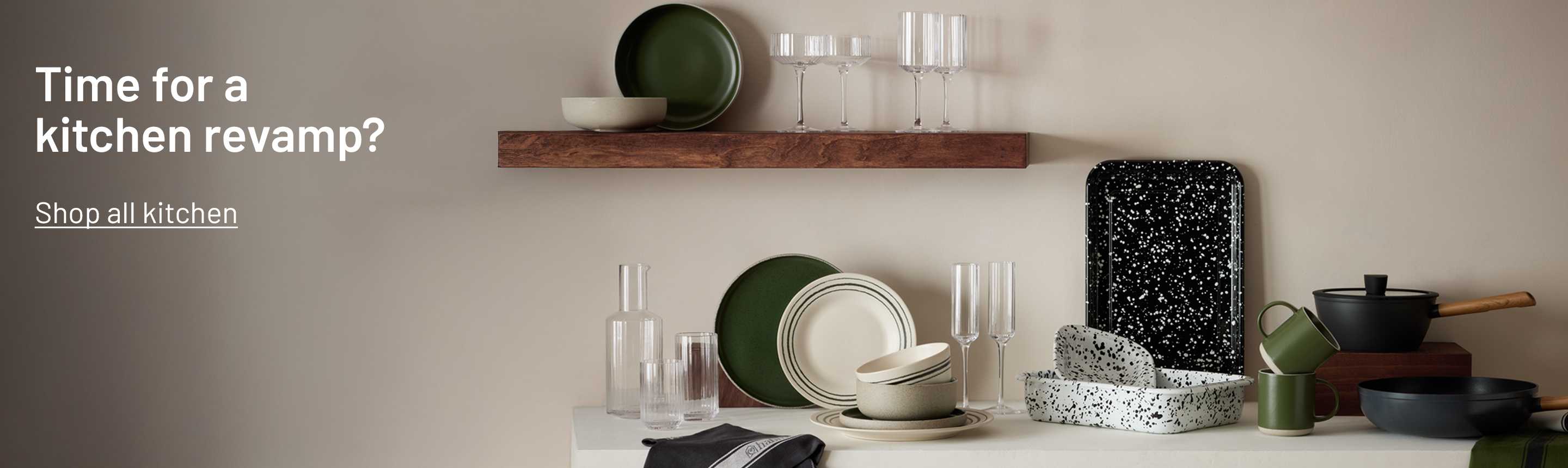 Habitat Splatter Enamel pie dish, baking tray and other dinnerware and glassware sets displayed on a white kitchen counter.