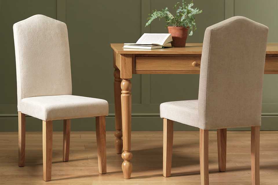 Two wooden chairs near a rectangular dining table.