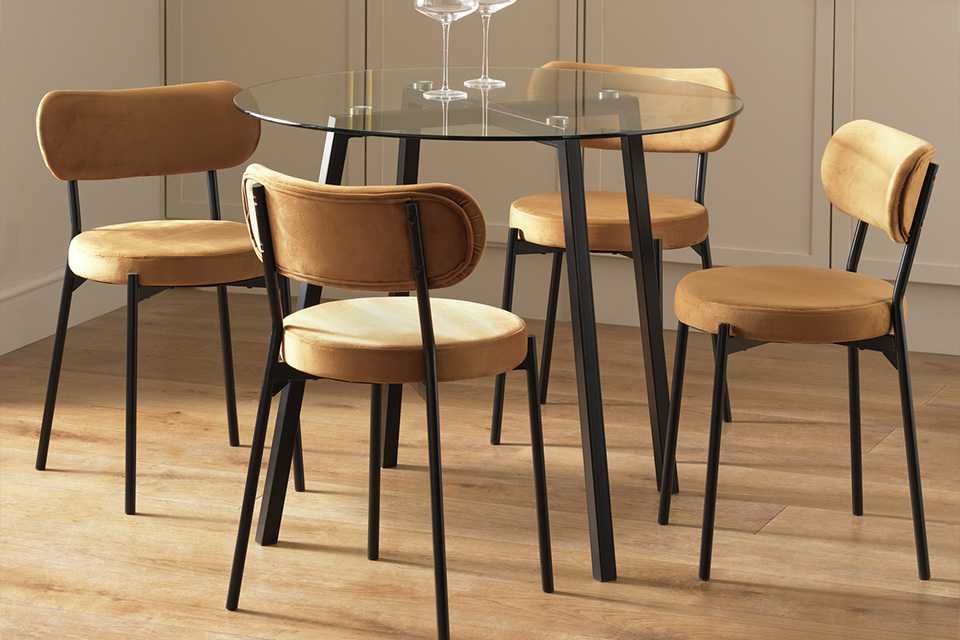 A glass-top four seater dining set.