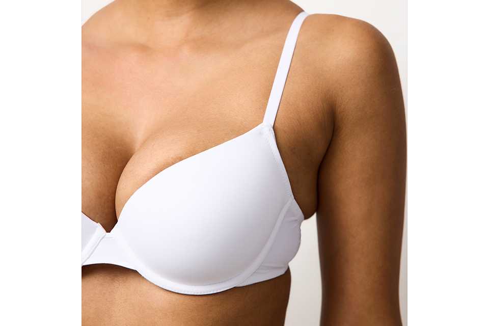 A woman wearing a white bra.