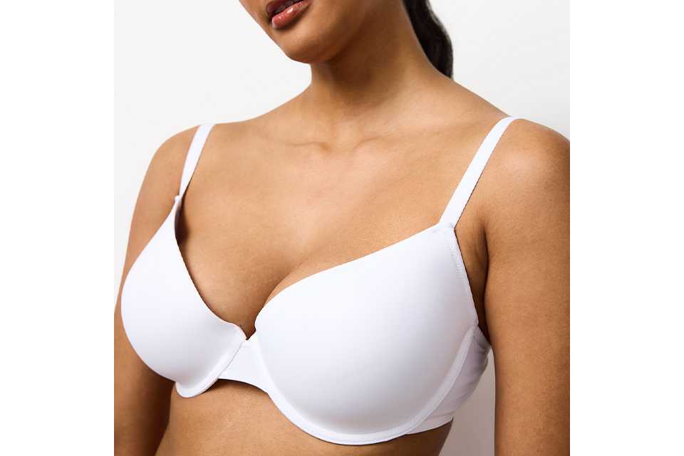 A woman wearing a white bra.