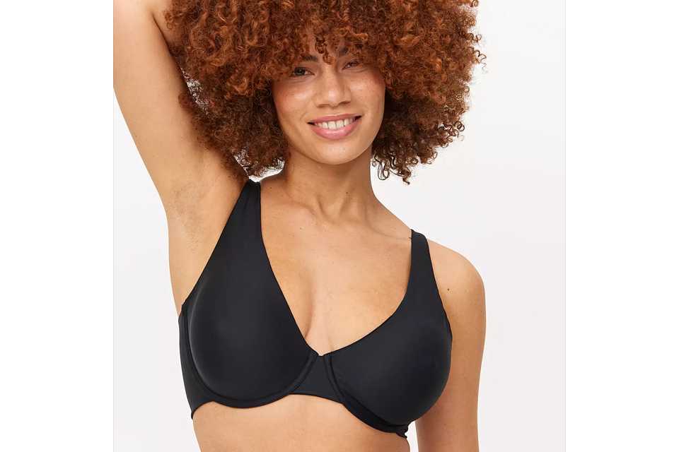 A woman wearing a black bra which will be DD-J in cup size.