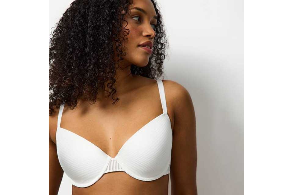 A woman wearing a white t-shirt bra.