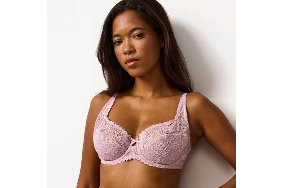 A woman wearing a pink full cup lace bra.