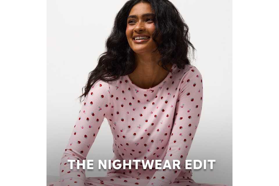 Person wearing pink nightwear top with a subtle heart pattern from the nightwear edit.