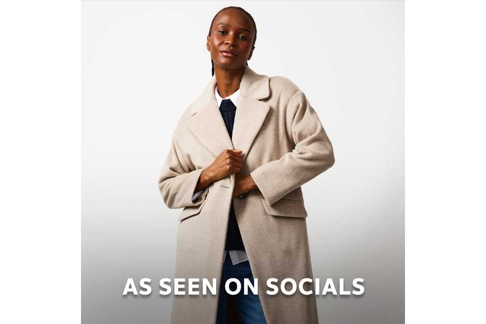 Model wearing a neutral long coat styled for social media fashion trends.
