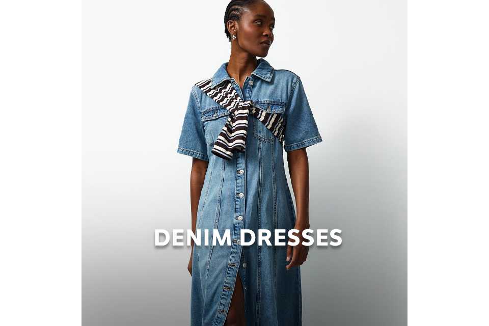 Person wearing a blue denim dress styled with a striped scarf for an elevated casual look.