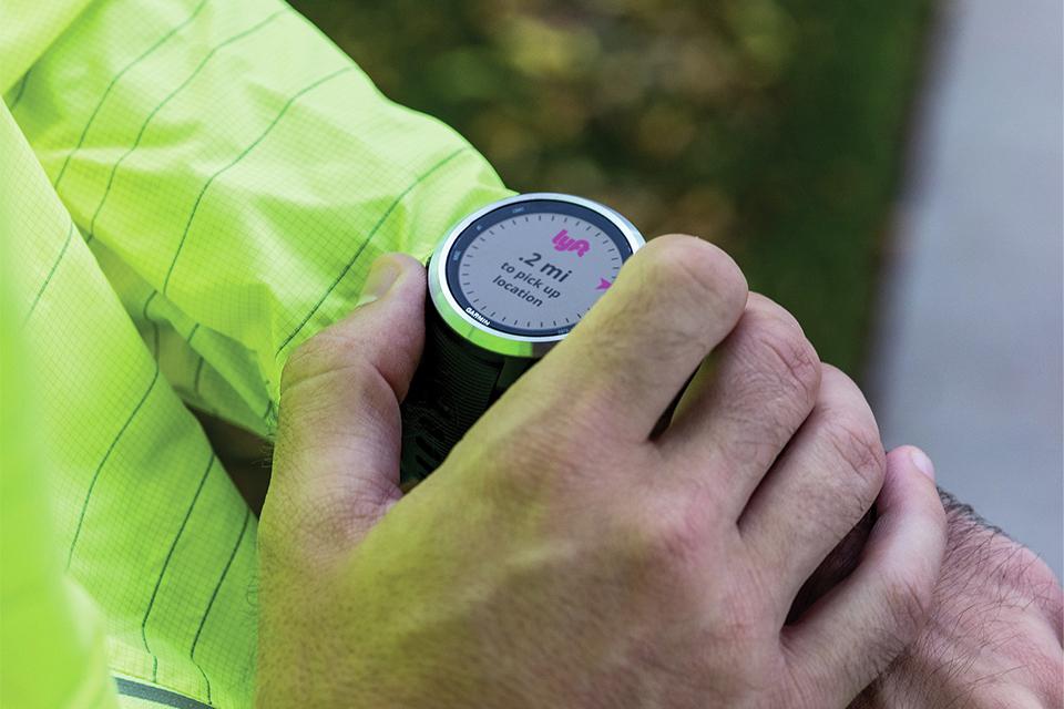 A man checking his running watch.