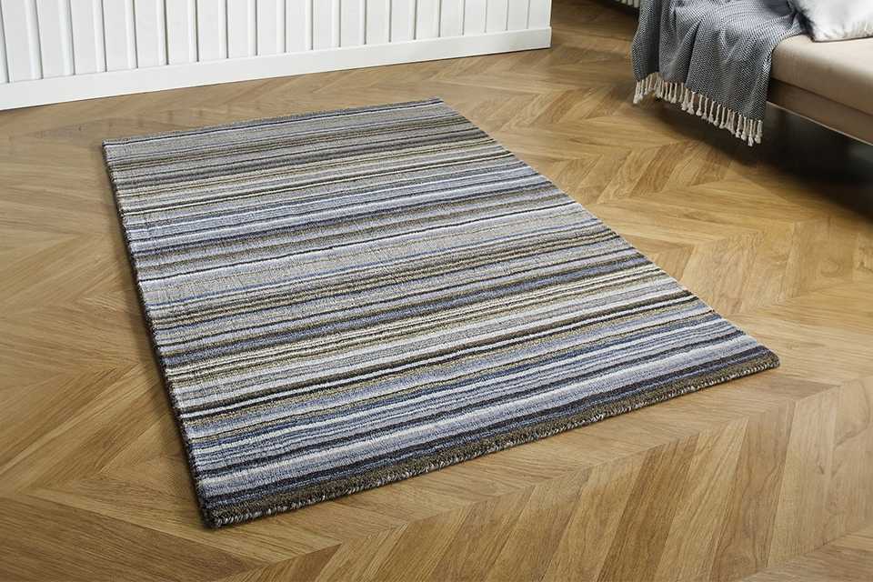 A Homemaker Connor skinny stripe grey wool cut pile rug in a living room.