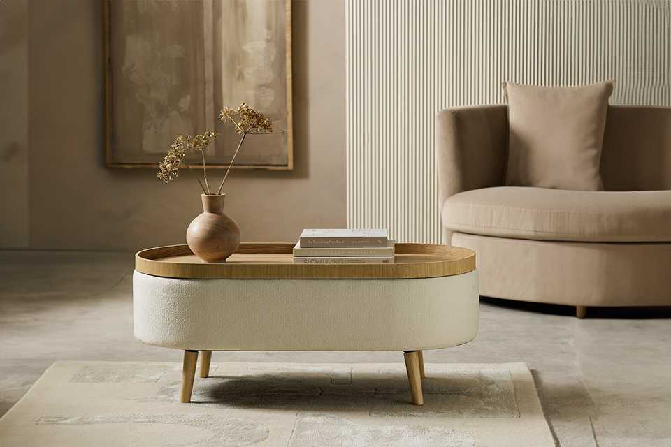 Habitat Ingo coffee table in cream colour placed in front of an armchair.