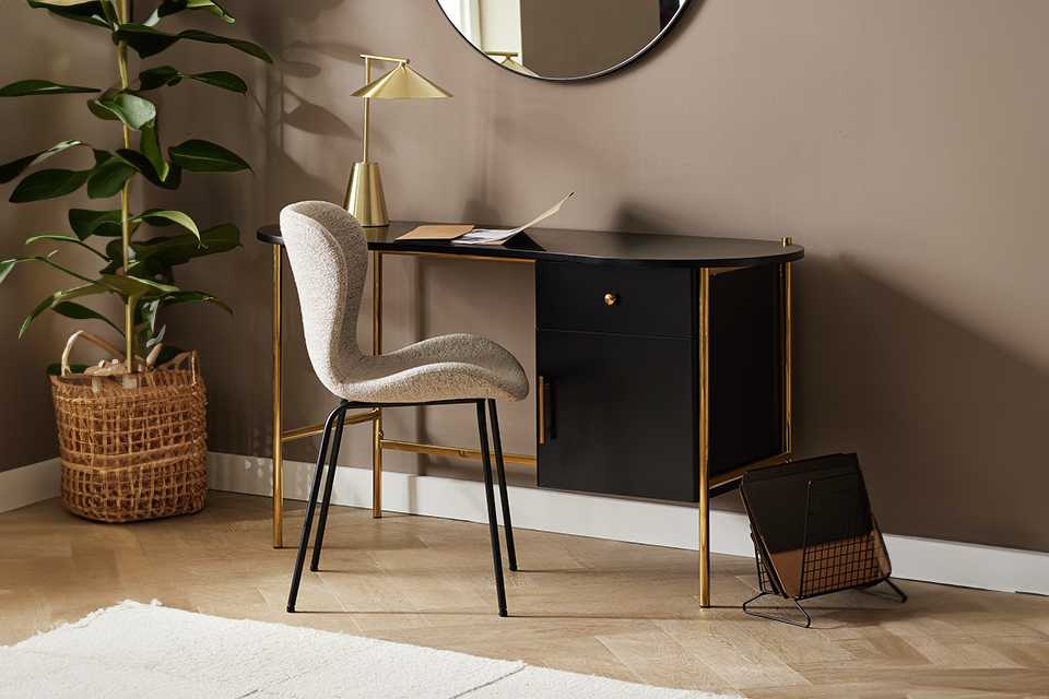 Habitat Jelly Bean storage desk black and gold finish with a gold finish lamp placed on it.