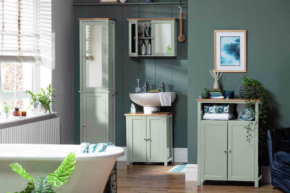 Argos Home Livingston bathroom furniture set including a tall boy, under sink storage, a mirrored cabinet and more in sage green colour.