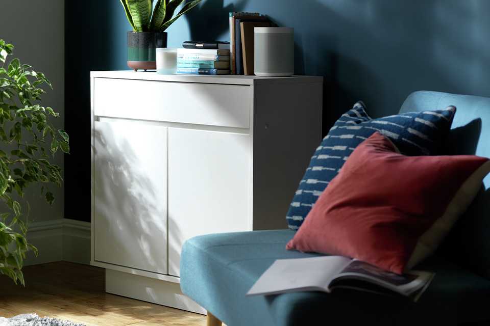 Argos Home Cubes SML sideboard in white colour placed next to a blue armchair.