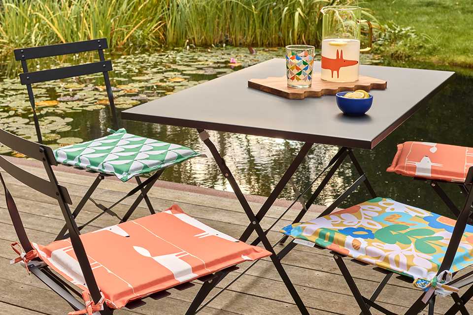 Cutting a box hedge with hand shears.