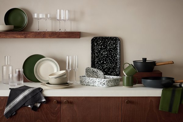 Habitat Splatter Enamel pie dish, baking tray and other dinnerware and glassware sets displayed on a white kitchen counter.