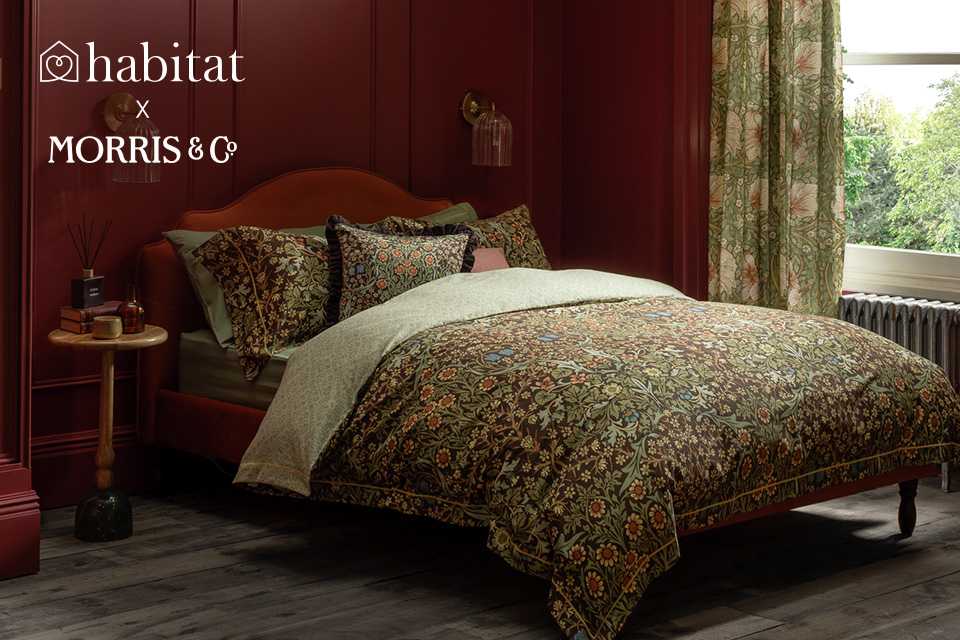Habitat x Morris & Co. collaboration Blackthorn Bedding set on an orange bed placed in a red bedroom.
