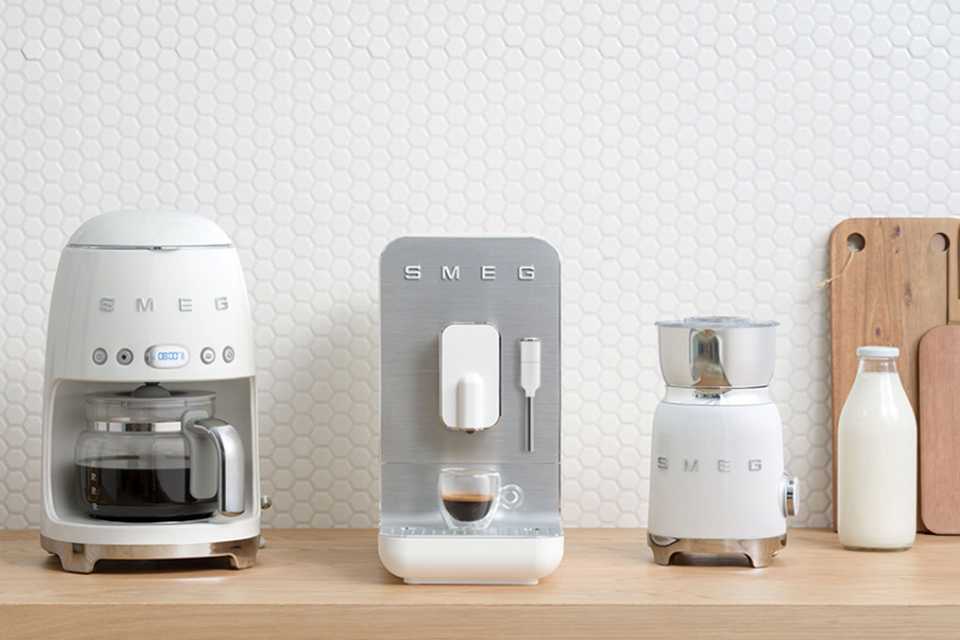 White Smeg drip coffee machine, bean to cup and milk frother.