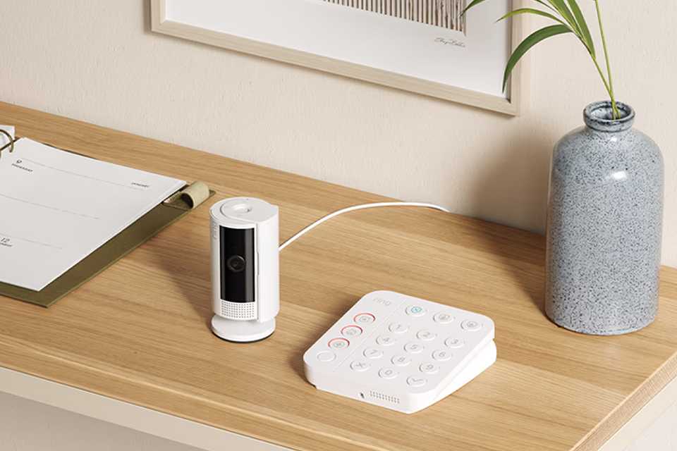 A white Ring alarm set placed on a table.