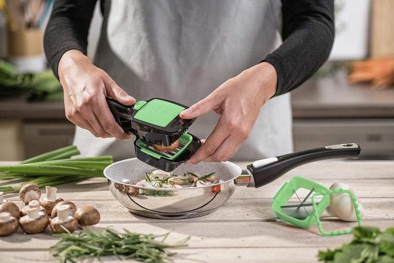 The JML Nicer Dicer Quick being used to dice mushrooms over a saucepan.