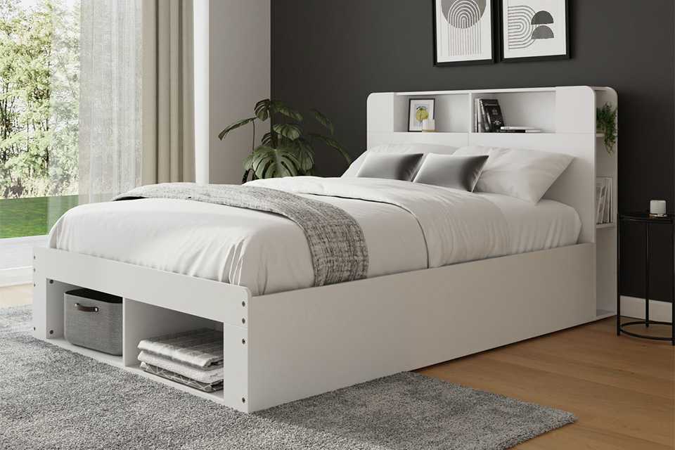 A kingsize ottoman bed in a grey and white painted room.