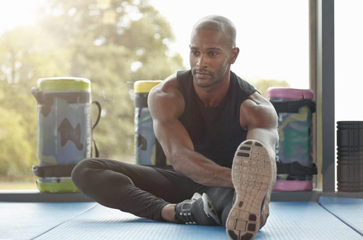 Man stretching inside before a run.