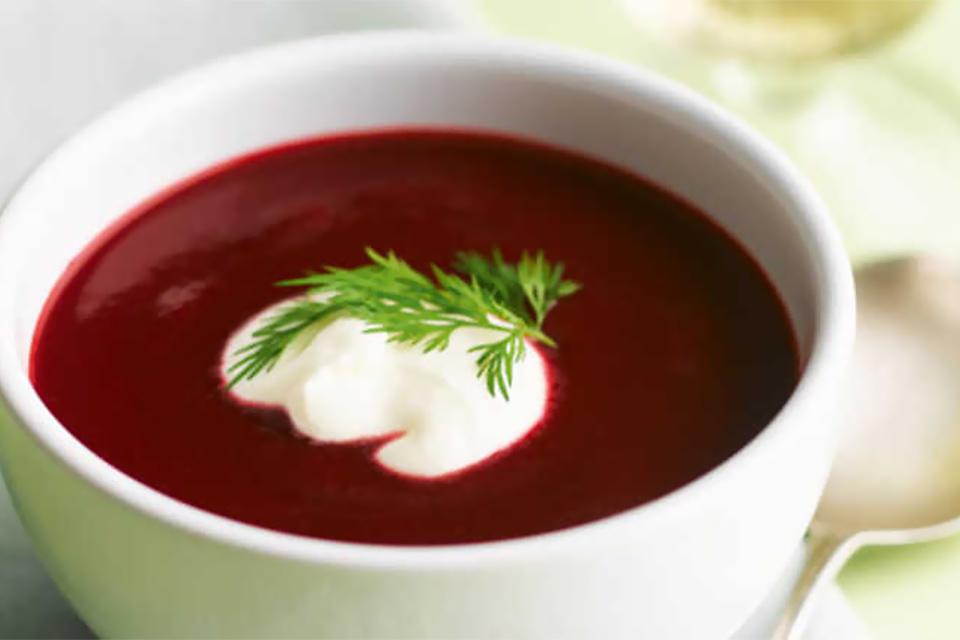 Prepared beetroot soup with garnish.