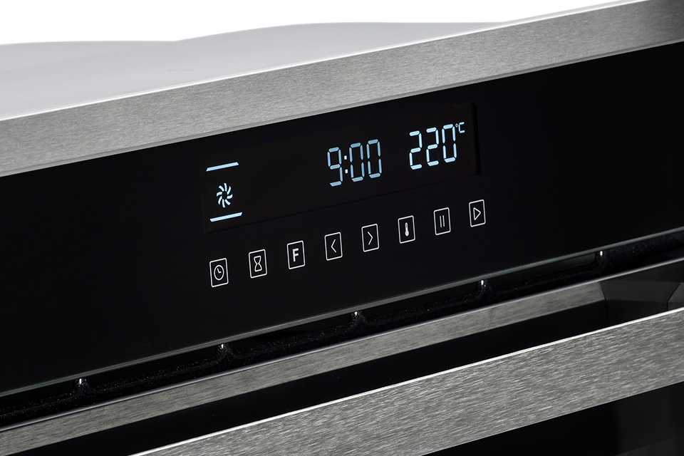 A black and silver oven with timer.