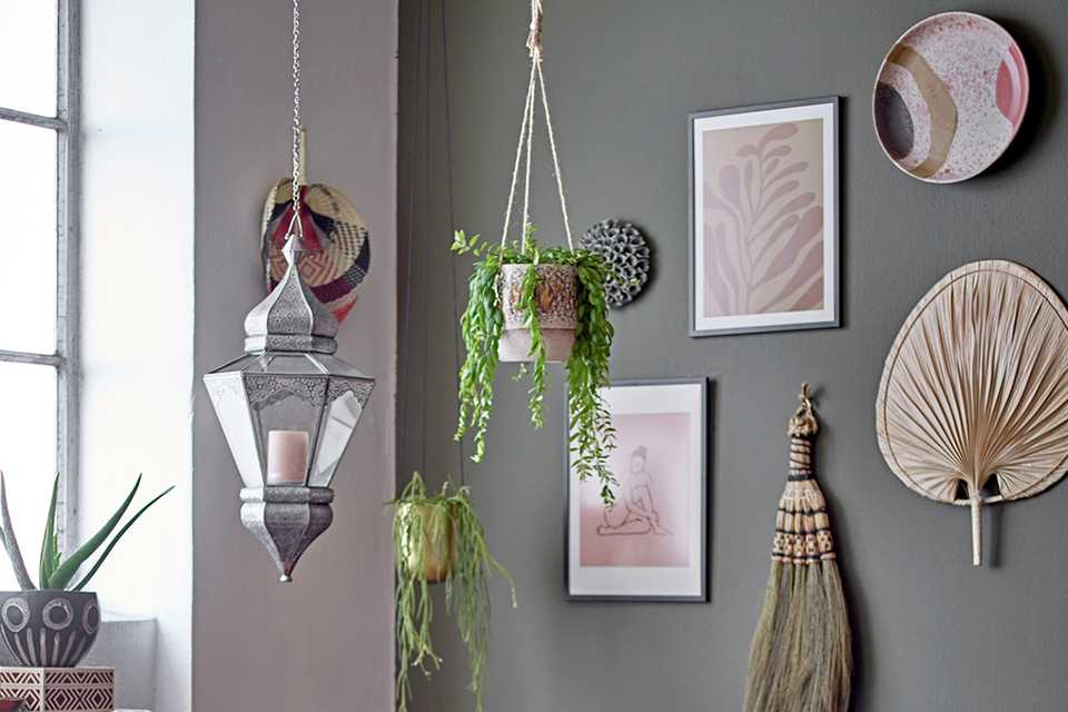 Bloomingville Palm Leaf Wall Décor in natural finish hung on a grey wall.