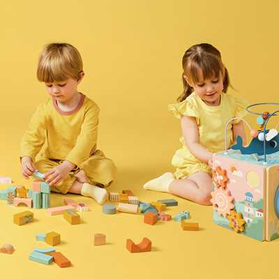 Two kids playing with educational activity toys.