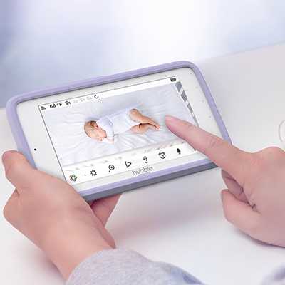 A parent watching their child over a baby monitor.