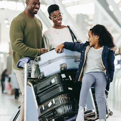 A family setting off on holiday with some suitcases.