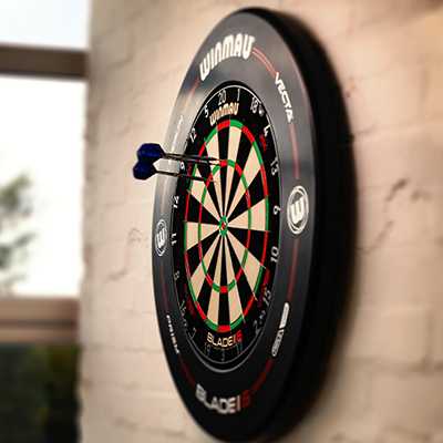 A dartboard on a wall with two darts on it.
