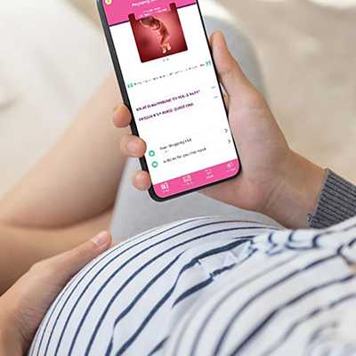 An expecting woman looking at Emma's diary on a phone.