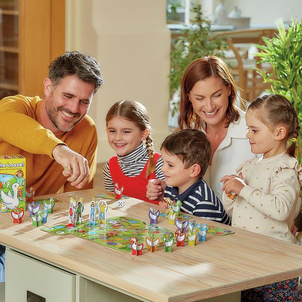 A family playing a board game at a table.