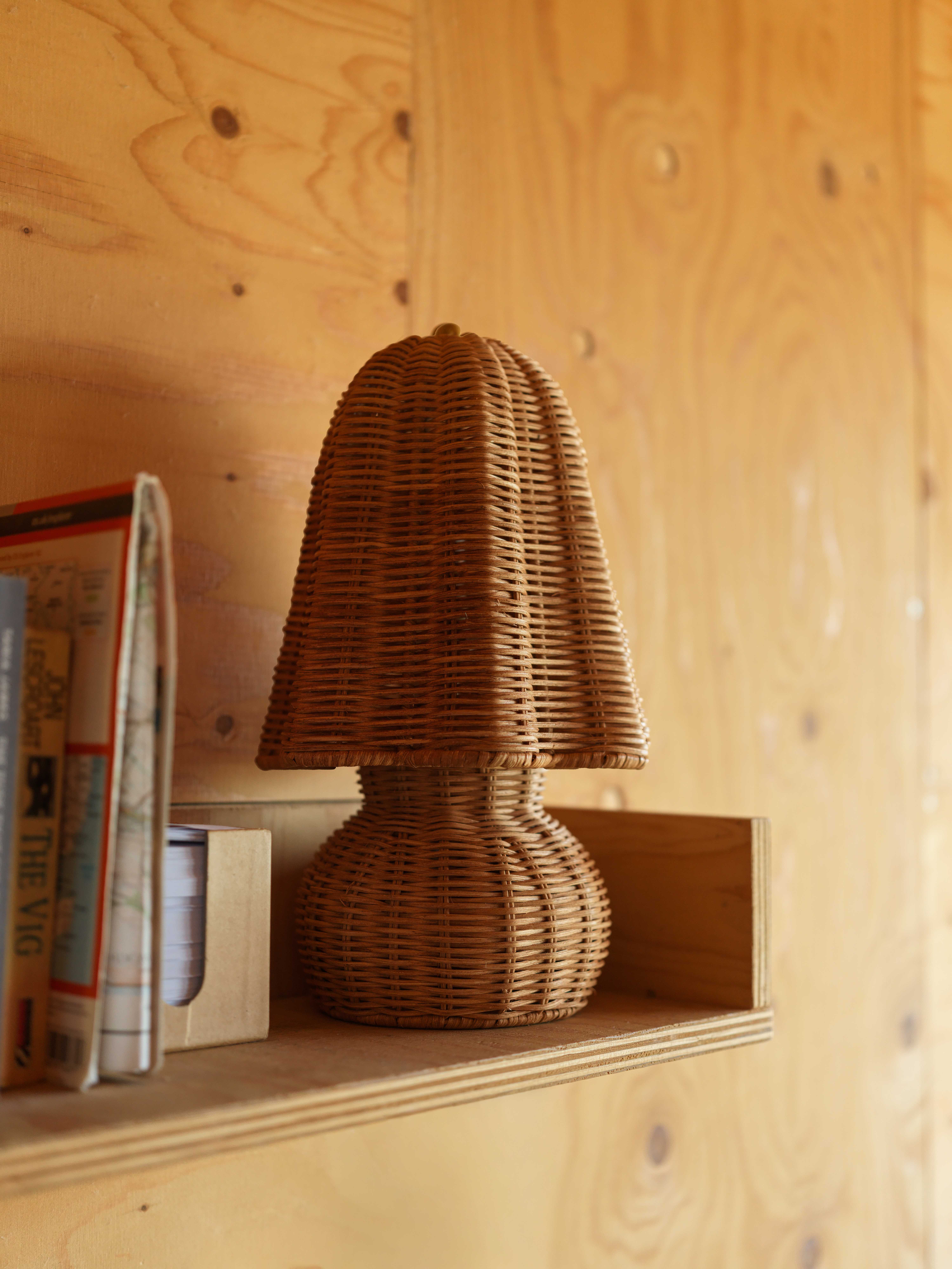 wicker lamp on wooden shelf