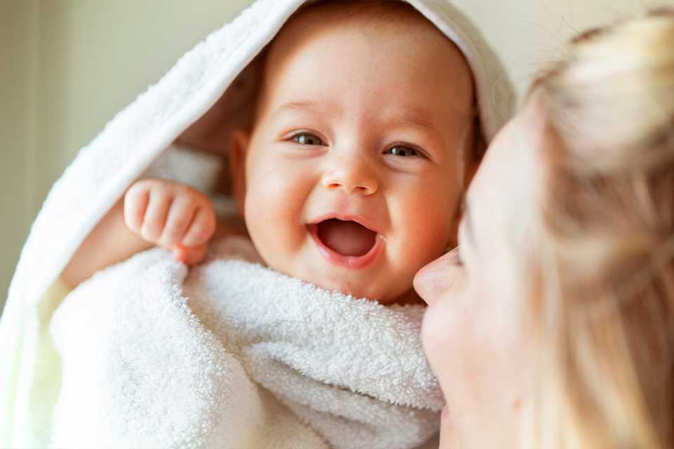 baby held by mother