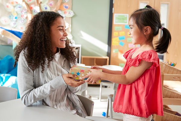 child giving present to a teacher