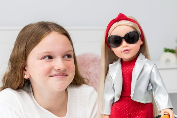 A girl playing with a Connie doll.