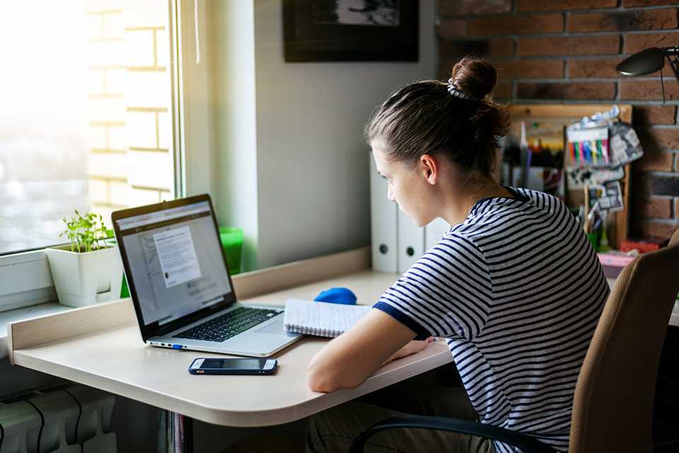 A woman working from home on her laptop.