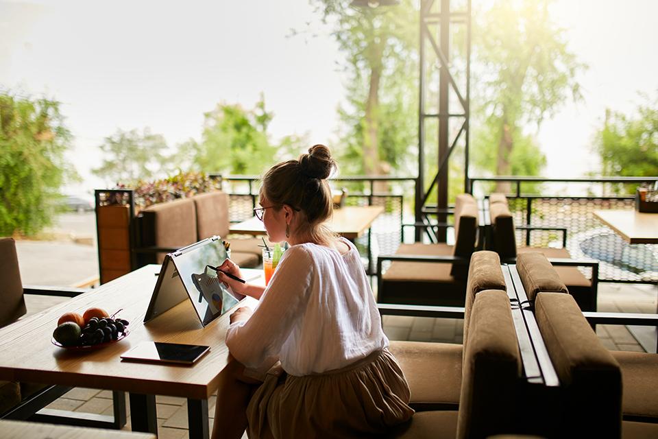 A woman working on her laptop on a tent mode.