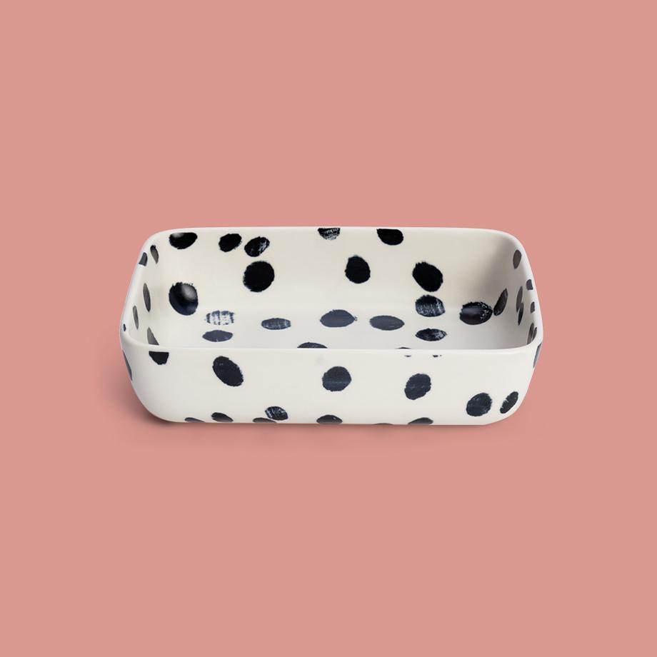 A Habitat white medium roaster with black brushstroke prints on it.