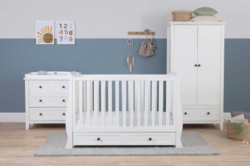 Silver Cross Nostalgia furniture set including a white dresser, a cot bed and a wardrobe, with a bottom drawer and knobs.