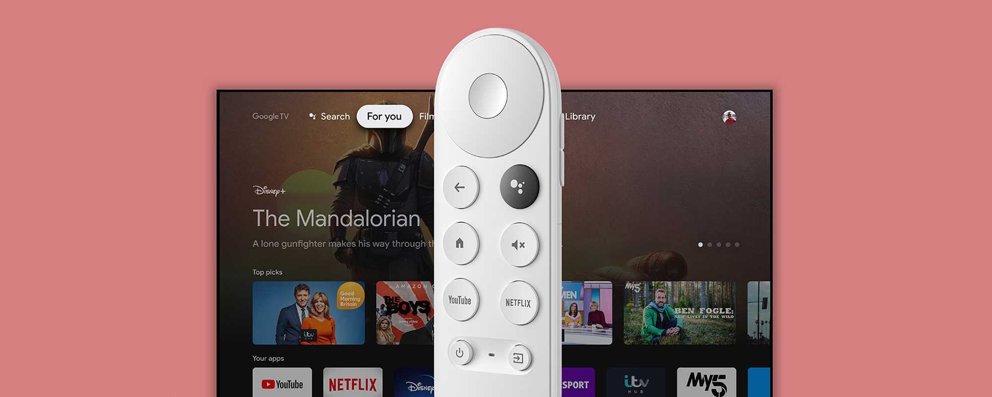 A white Google voice remote in front of a smart LED TV.