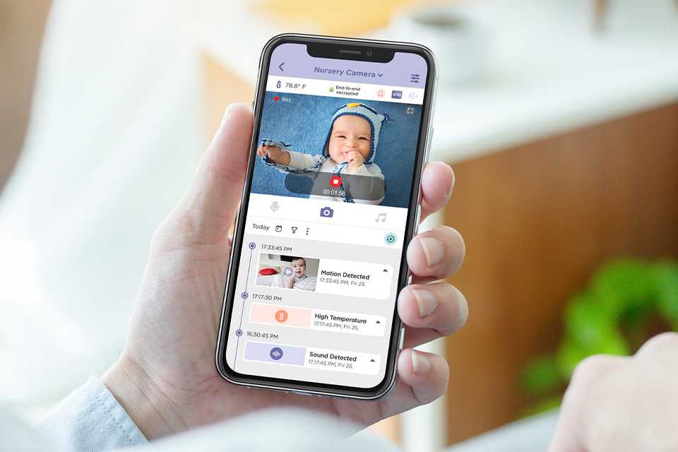 A man checking on his baby on smart baby monitor app on his phone.