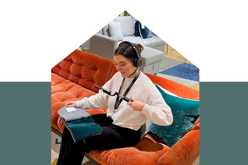 A Habitat colleague uses a camera to focus on a fabric swatch.
