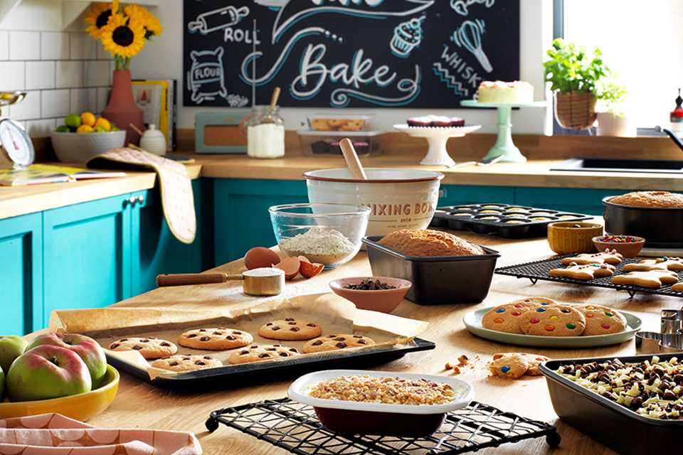 Fruits, cookies and other baked goods on a kitchen table.