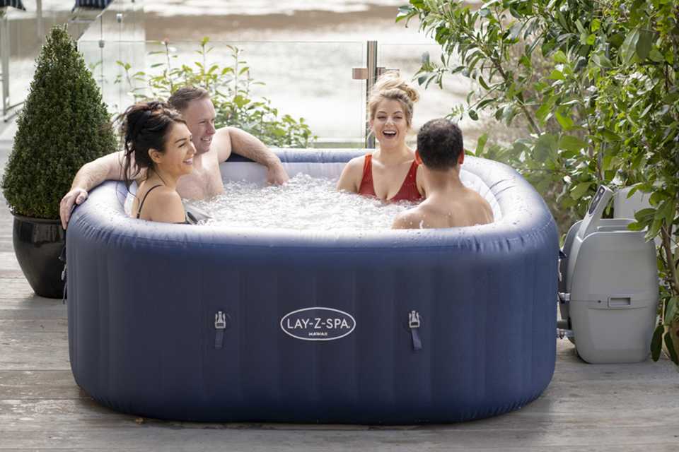 A group of friends sitting in a Lay-Z-Spa hot tub.