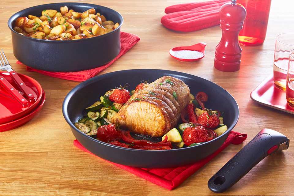 A dish served in Tefal Ingenio cookware, doubling up as serving dish; next to the detachable handle, pepper mill and other tableware.