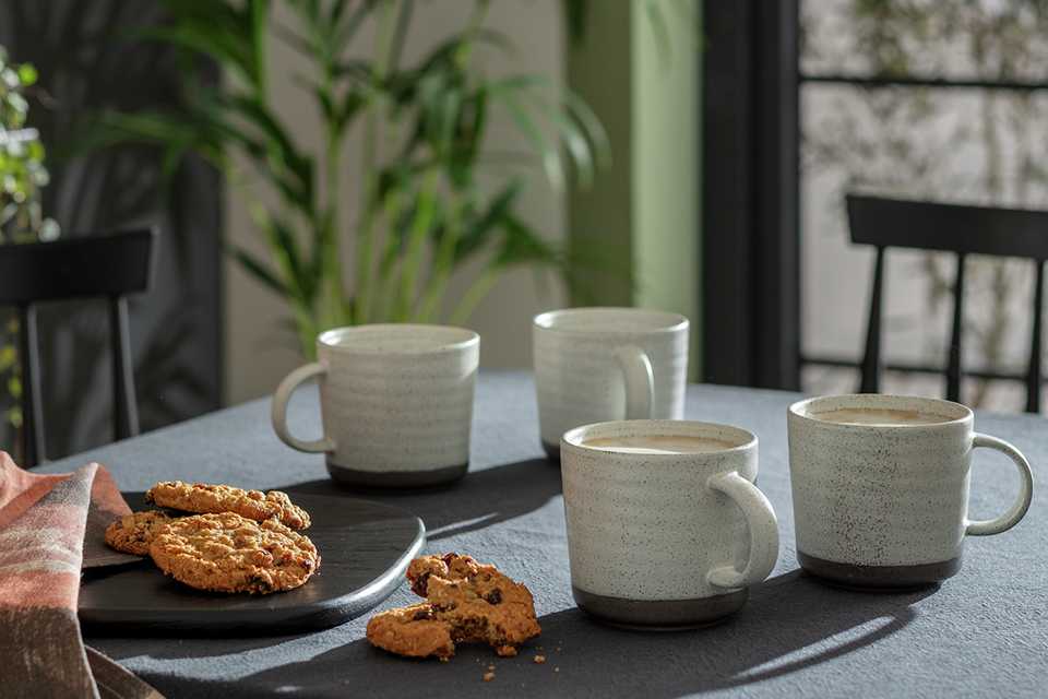 A set of 4 Habitat ripple textured mugs on a dining table.